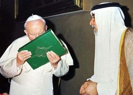 Pope John Paul kissing a copy of the Holy Quran 